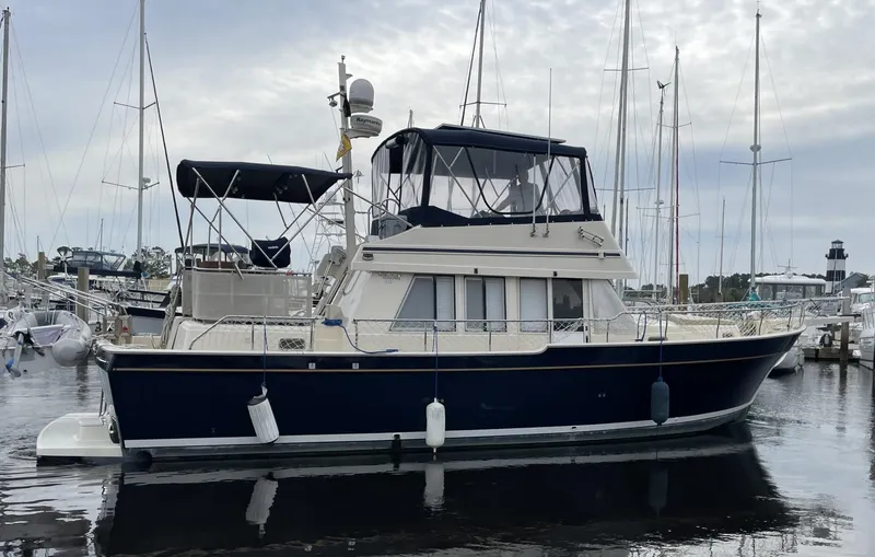 Slide: The Image of 2005 Mainship 430 Aft Cabin 3SR Trawler docked at marina. - 7