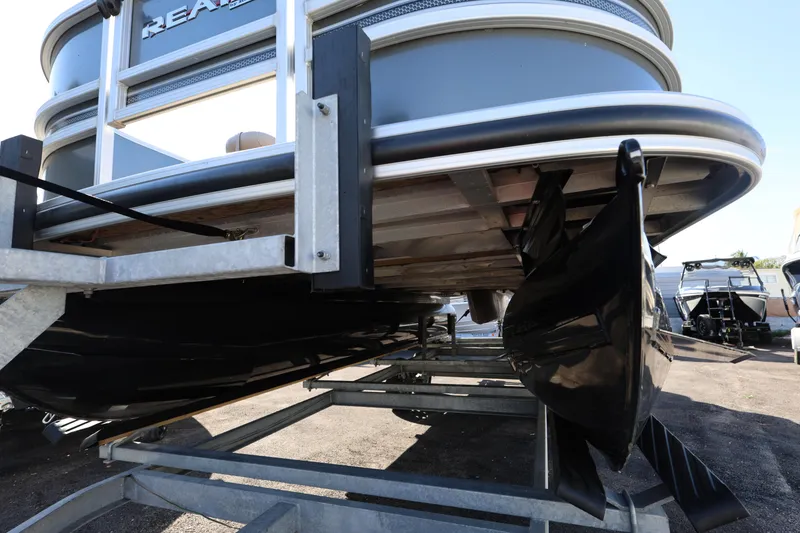 Slide: The Image of 2017 Ranger Reata 200F pontoon boat on trailer, close-up view of hull and pontoons. - 27