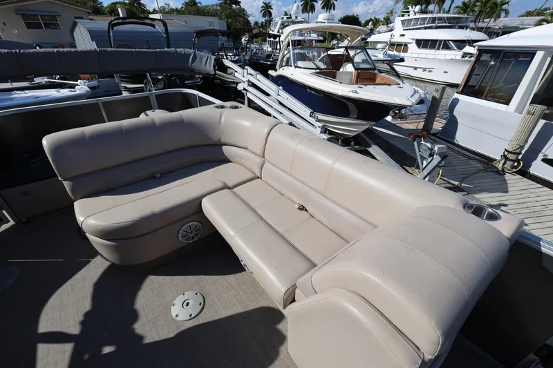 Slide: The Image of 2017 Ranger Reata 200F boat with beige seating at a marina. - 31