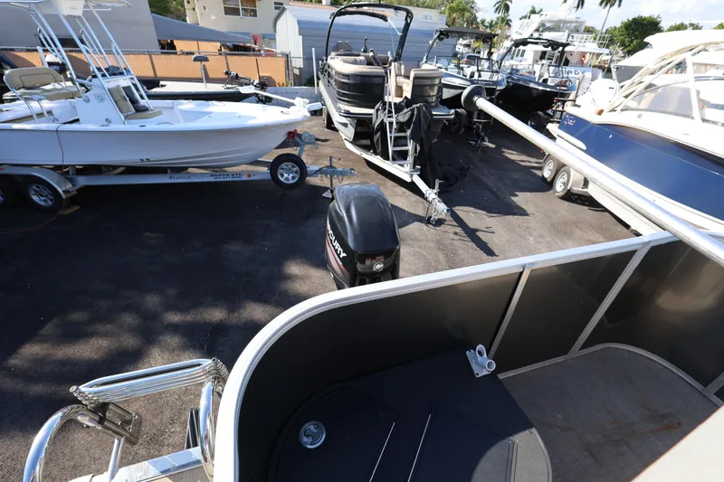 Slide: The Image of 2017 Ranger Reata 200F boat in a marina with other boats. - 34