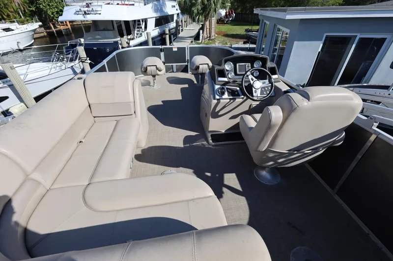 Slide: The Image of 2017 Ranger Reata 200F pontoon boat interior with beige seating and steering console. - 35