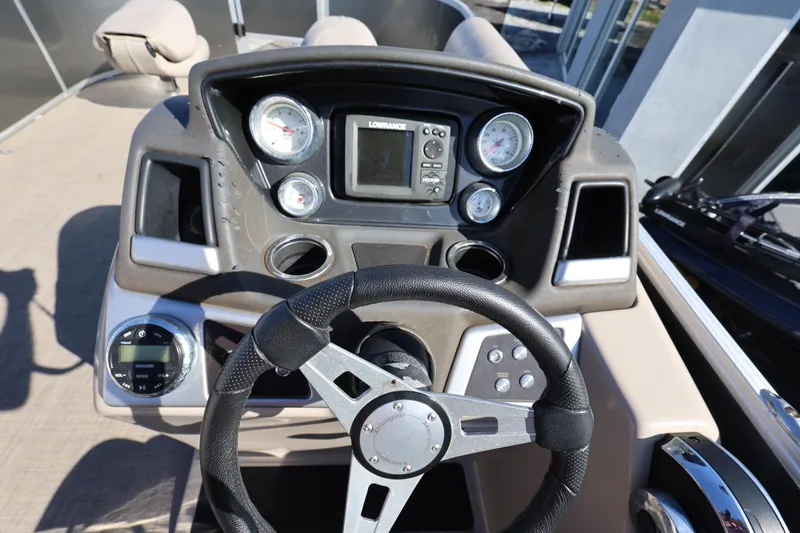Slide: The Image of 2017 Ranger Reata 200F boat dashboard with steering wheel and gauges. - 37