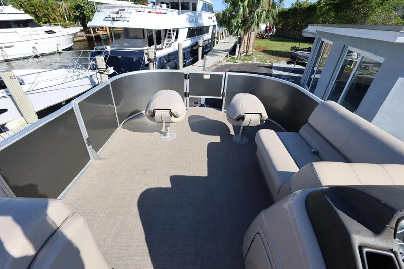 Slide: The Image of 2017 Ranger Reata 200F boat interior with seating, docked near yachts. - 38