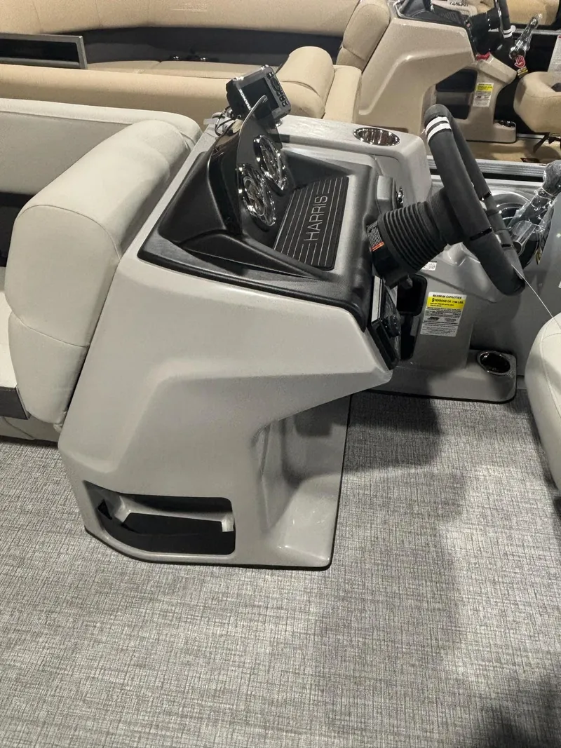 Slide: The Image of 2025 Harris CRUISER 230 SL boat interior with modern steering console and seating. - 11