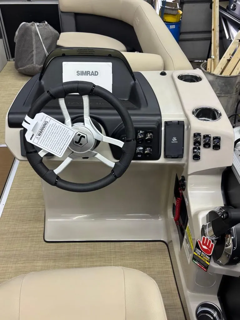 Slide: The Image of 2025 Harris CRUISER 230 SL boat dashboard with steering wheel and control panel. - 13