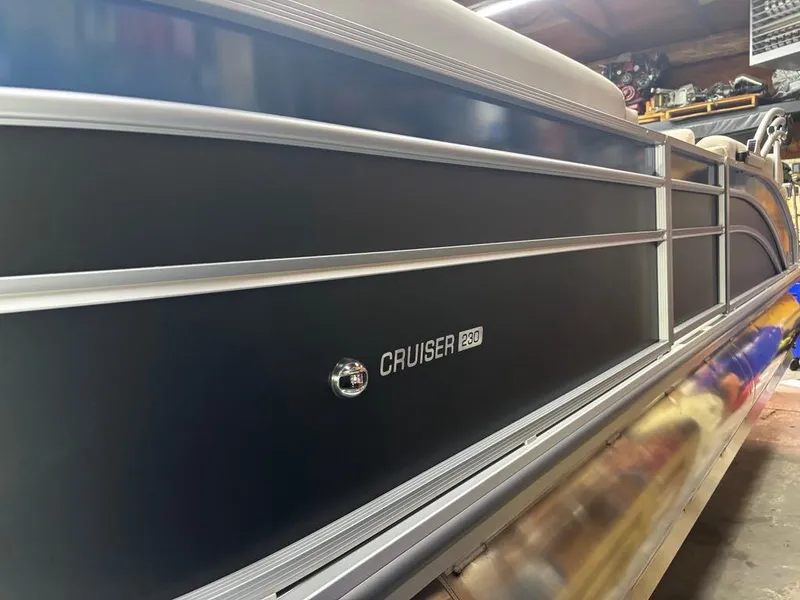 Slide: The Image of 2025 Harris CRUISER 230 SL pontoon boat in a garage setting. - 15