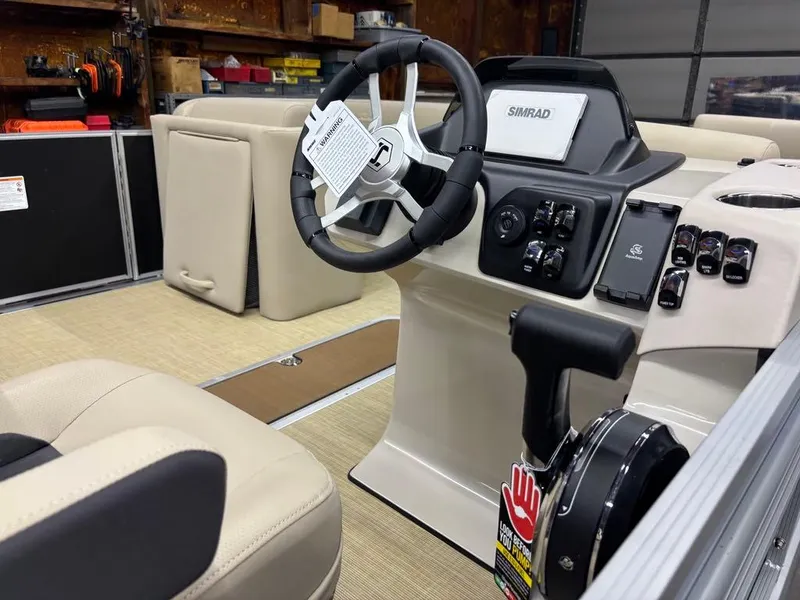 Slide: The Image of Interior of 2025 Harris CRUISER 230 SL boat with steering wheel and control panel. - 3