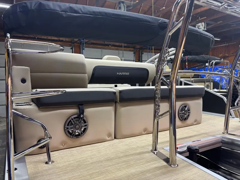 Slide: The Image of 2025 Harris CRUISER 230 SL boat interior with plush seating and sleek design. - 4