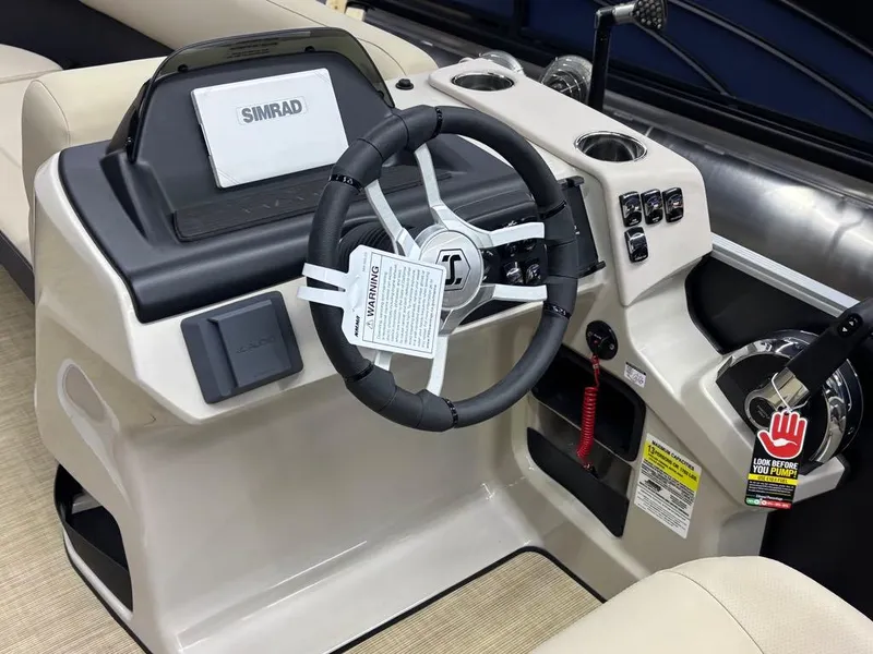 Slide: The Image of 2025 Harris CRUISER 230 SL boat dashboard with steering wheel and Simrad display. - 5