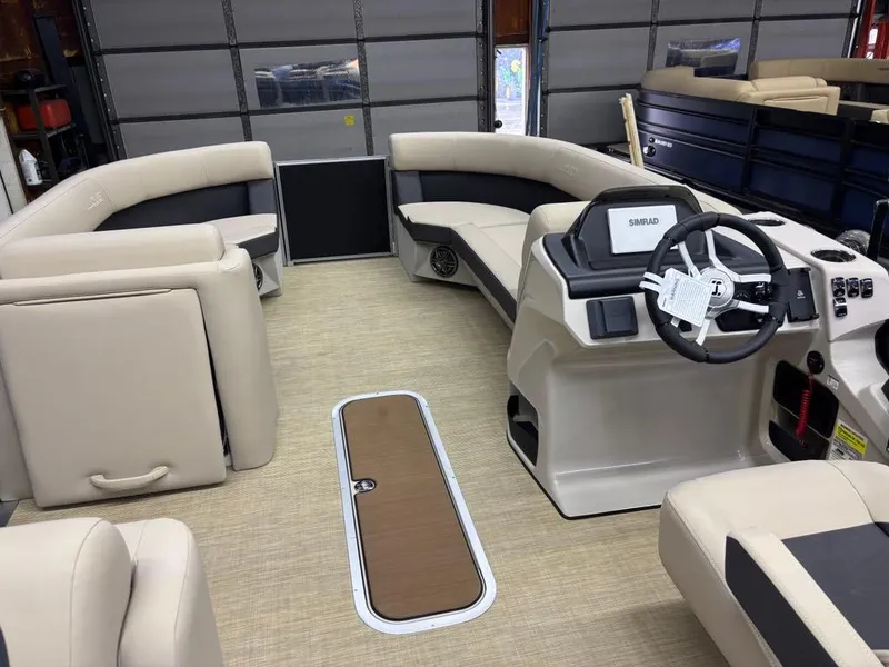 Slide: The Image of 2025 Harris CRUISER 230 SL interior with beige seating and modern steering console. - 6