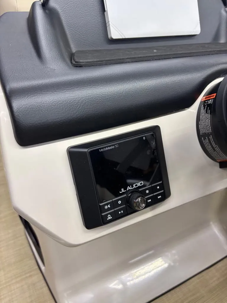 Slide: The Image of 2025 Harris CRUISER 230 SL dashboard with JL Audio system. - 7