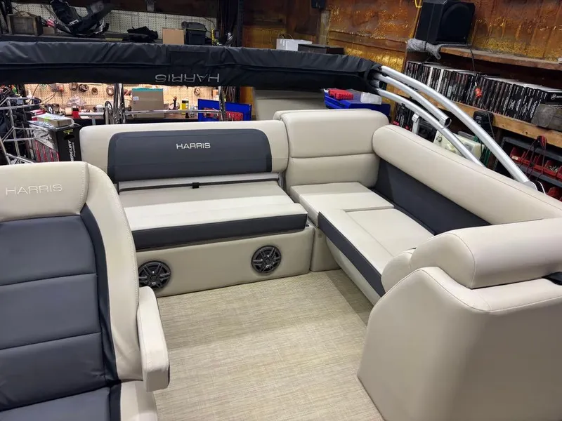 Slide: The Image of 2025 Harris CRUISER 230 SL boat interior with beige and gray seating. - 8
