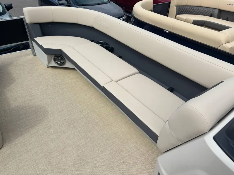 Slide: The Image of 2025 Harris Cruiser 230 boat interior with beige seating and speaker system. - 3