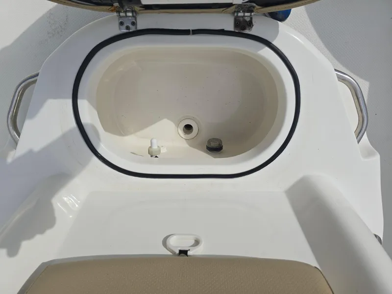 Slide: The Image of 2019 NauticStar 244 XTS boat livewell with open lid, showcasing interior details. - 10