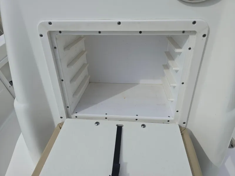 Slide: The Image of 2019 NauticStar 244 XTS boat storage compartment, open and empty. - 11