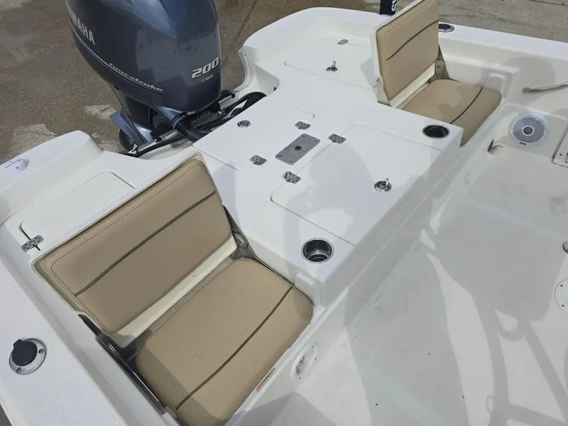 Slide: The Image of 2019 NauticStar 244 XTS boat interior with beige seating and Yamaha 200 engine. - 13