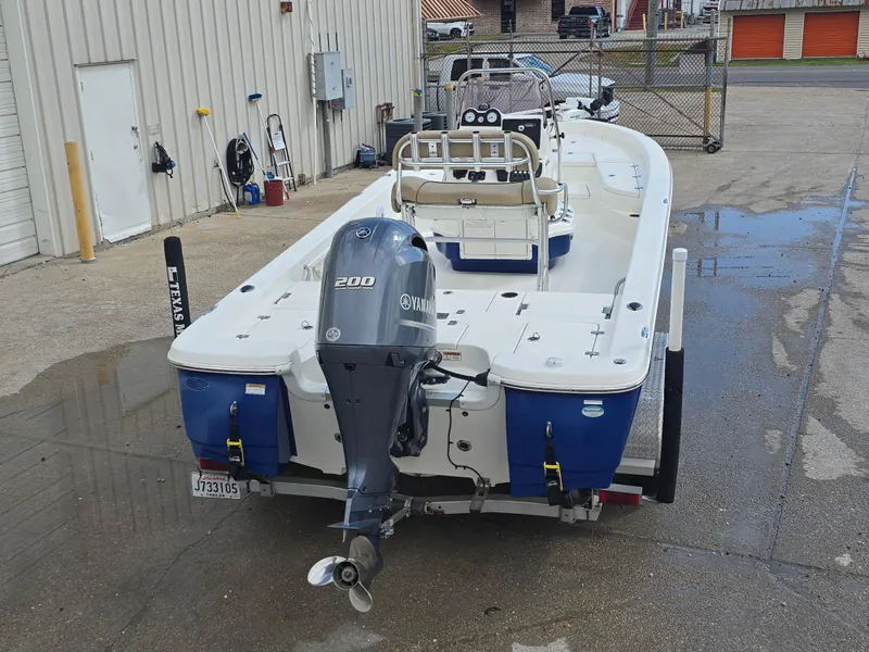 Slide: The Image of 2019 NauticStar 244 XTS boat with Yamaha 200 engine, parked outdoors. - 5
