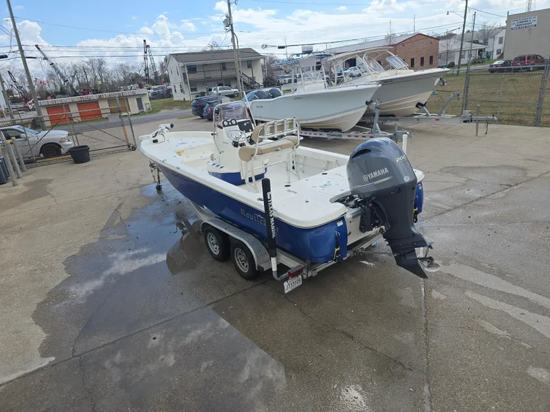 Slide: The Image of 2019 NauticStar 244 XTS boat with Yamaha engine on a trailer in a parking lot. - 6