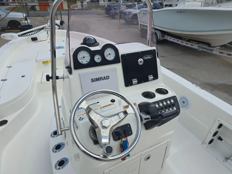 Slide: The Image of 2019 NauticStar 244 XTS boat console with steering wheel and Simrad electronics. - 8