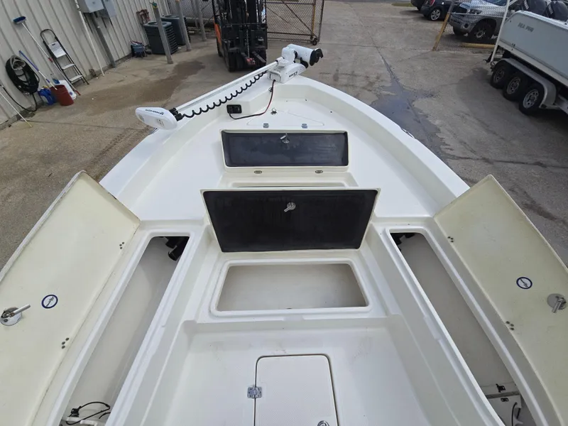 Slide: The Image of 2019 NauticStar 244 XTS boat deck with storage compartments open. - 9