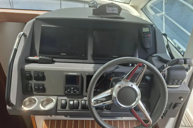Slide: The Image of Control panel of 2017 Nimbus 405 Flybridge with steering wheel and navigation equipment. - 18