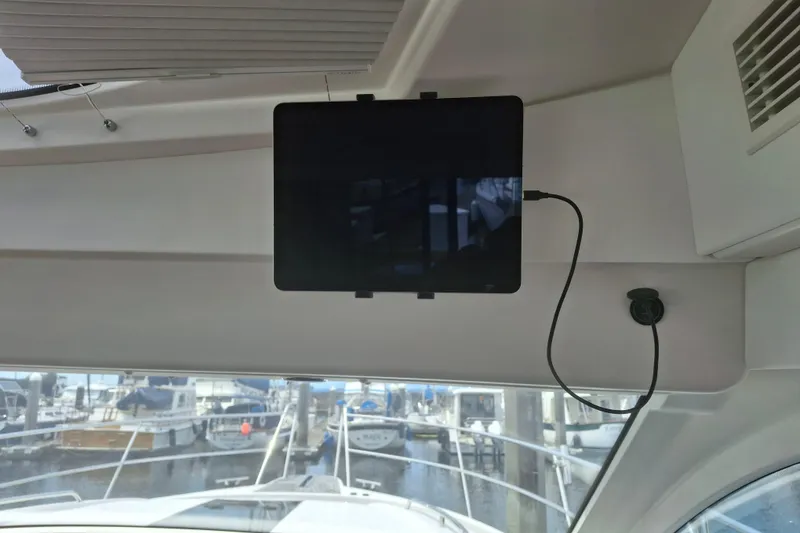 Slide: The Image of Interior of 2017 Nimbus 405 Flybridge with mounted tablet and marina view. - 19