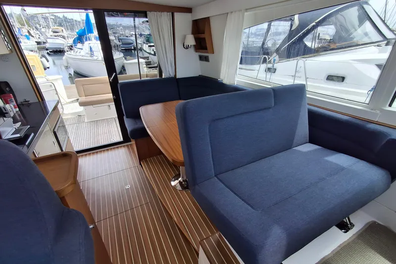 Slide: The Image of Interior of 2017 Nimbus 405 Flybridge yacht with blue seating and wooden flooring. - 22