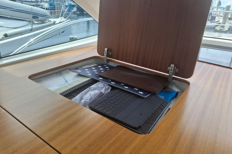 Slide: The Image of Storage compartment on 2017 Nimbus 405 Flybridge yacht with maps and accessories. - 24