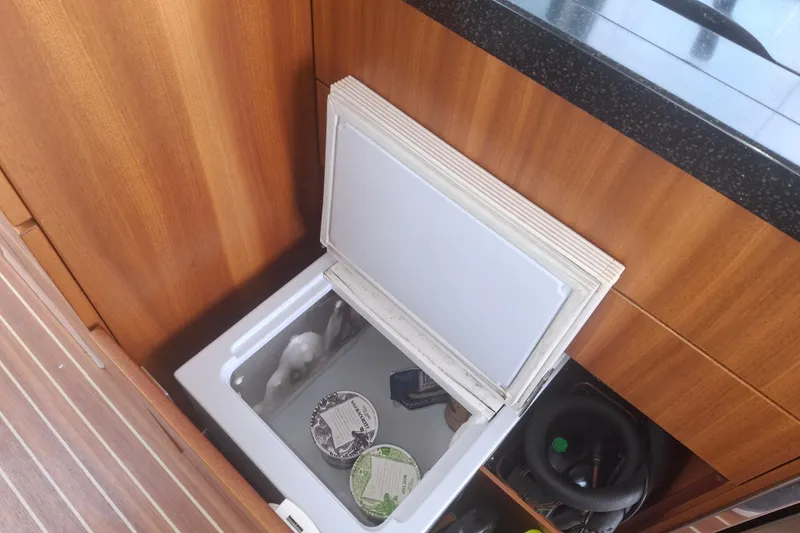 Slide: The Image of Open fridge on Nimbus 405 Flybridge 2017 yacht with wooden interior. - 27