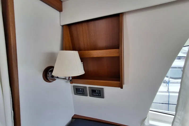 Slide: The Image of Interior of 2017 Nimbus 405 Flybridge yacht with wall lamp and wooden shelf. - 28