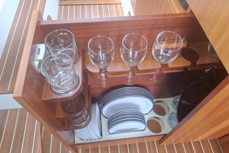Slide: The Image of Wooden cabinet with glassware and plates on a 2017 Nimbus 405 Flybridge yacht. - 29