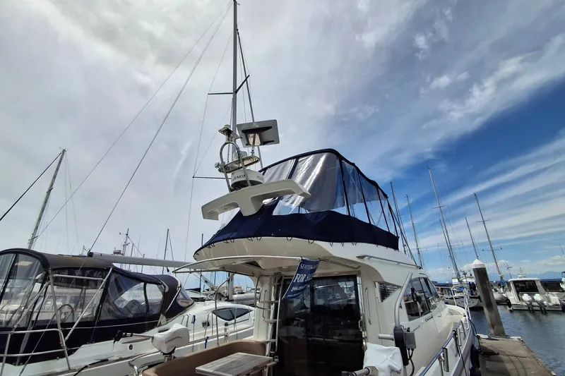 Slide: The Image of Nimbus 405 Flybridge 2017 yacht docked at marina under partly cloudy sky. - 3