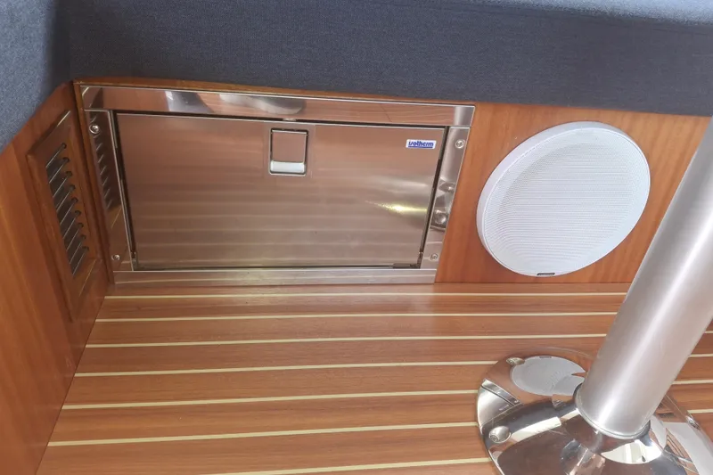 Slide: The Image of Interior of 2017 Nimbus 405 Flybridge with wood paneling, speaker, and stainless steel hatch. - 30