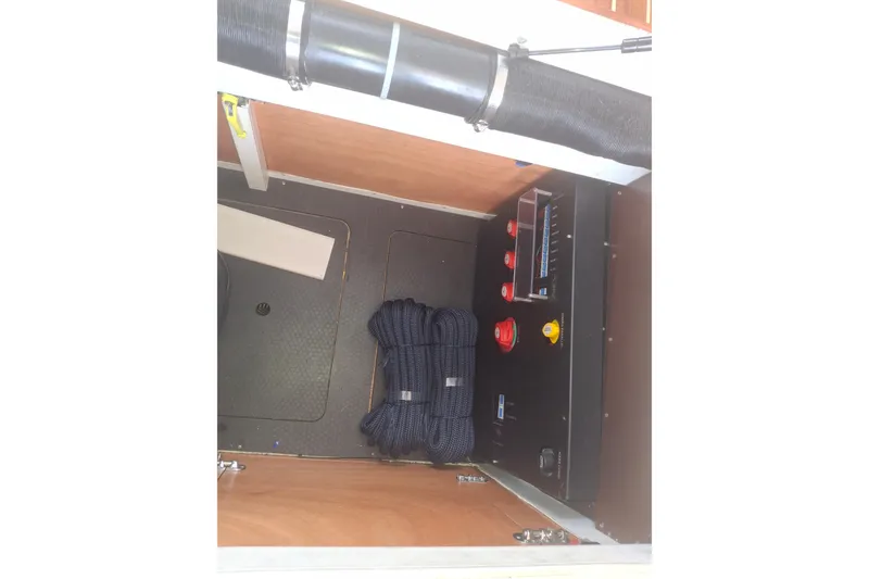 Slide: The Image of Engine compartment of 2017 Nimbus 405 Flybridge with coiled rope and control panel. - 31