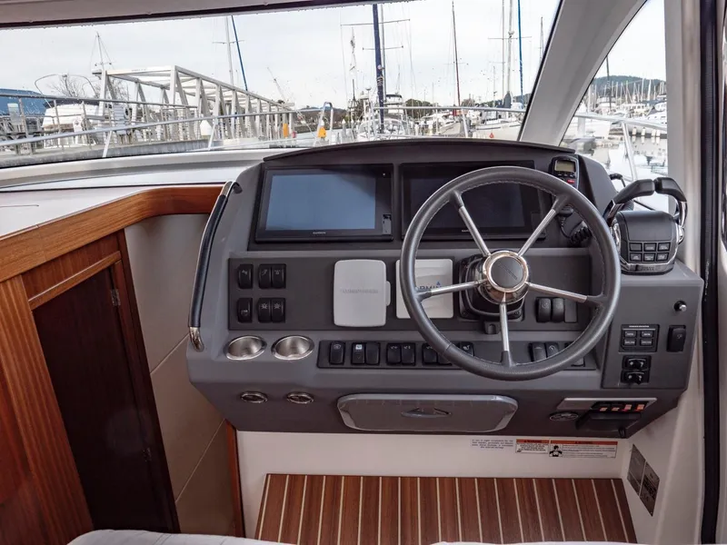 Slide: The Image of Helm of 2017 Nimbus 405 Flybridge yacht with modern controls and steering wheel. - 34