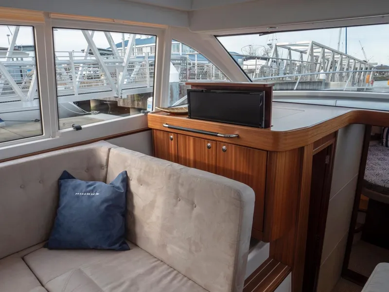 Slide: The Image of Interior of 2017 Nimbus 405 Flybridge yacht with plush seating and a retractable TV. - 35