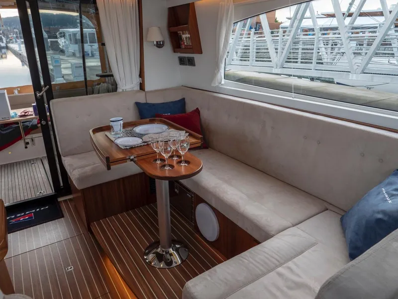 Slide: The Image of Interior of 2017 Nimbus 405 Flybridge yacht with cozy seating and elegant table setting. - 36