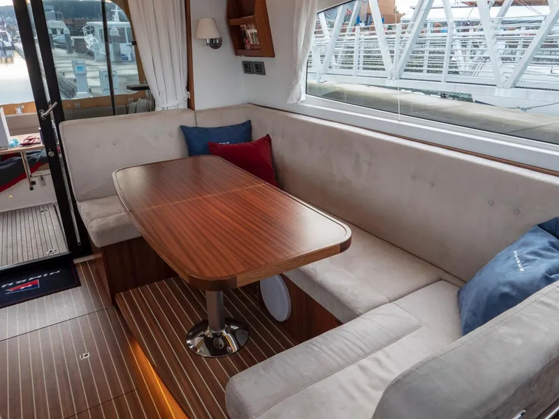 Slide: The Image of Luxurious interior of 2017 Nimbus 405 Flybridge with elegant wood table and plush seating. - 38
