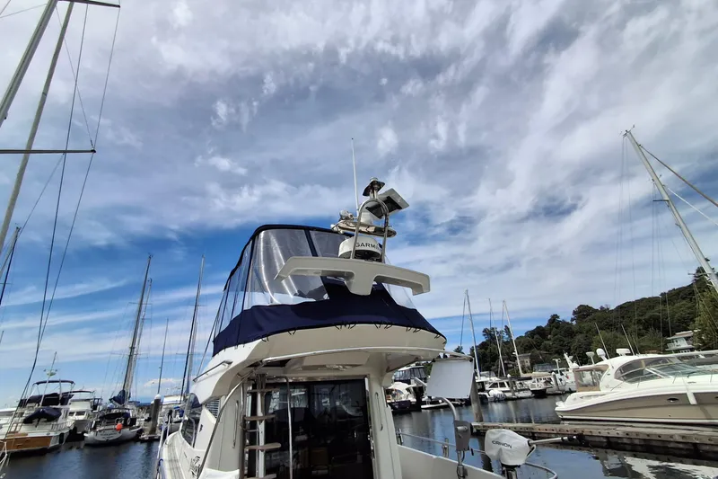 Slide: The Image of Nimbus 405 Flybridge 2017 yacht docked at marina under a partly cloudy sky. - 4