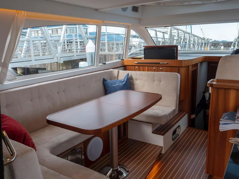Slide: The Image of Interior of 2017 Nimbus 405 Flybridge yacht with elegant seating and wooden table. - 41