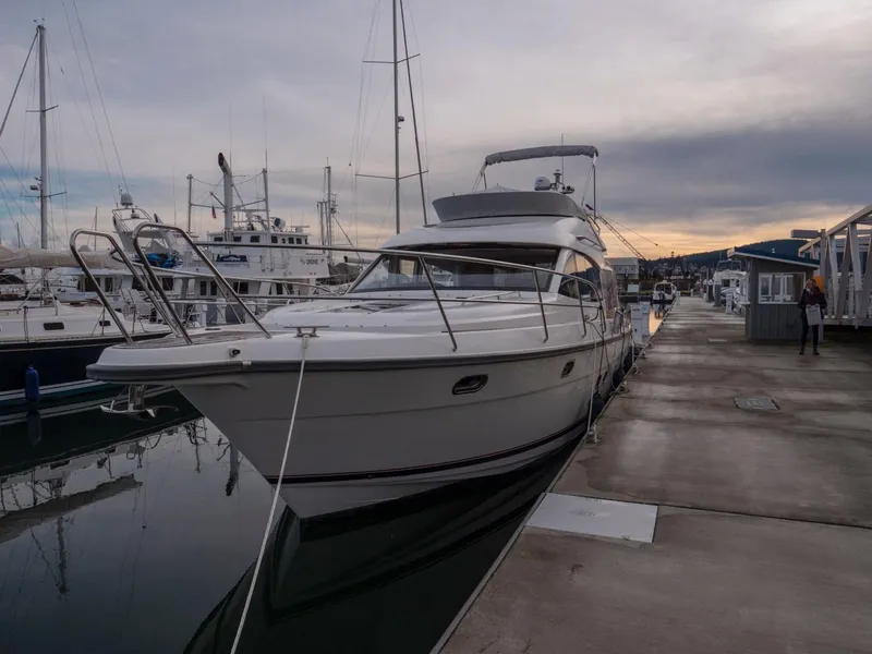 Slide: The Image of 2017 Nimbus 405 Flybridge yacht docked at marina during sunset. - 47