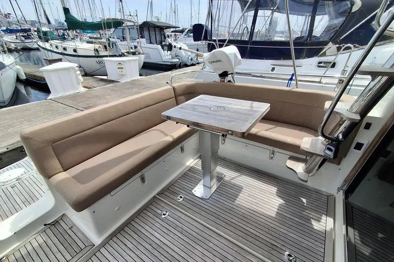 Slide: The Image of Luxurious seating area on a 2017 Nimbus 405 Flybridge yacht, docked at a marina. - 7