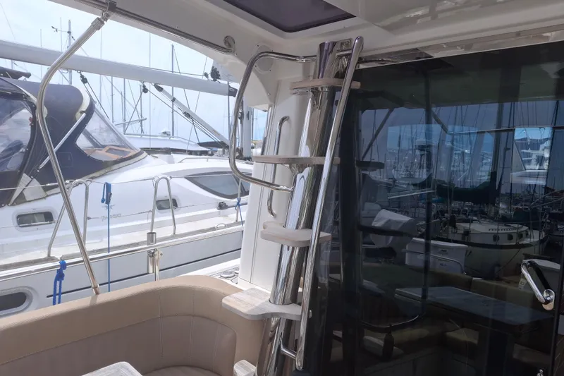 Slide: The Image of Interior view of 2017 Nimbus 405 Flybridge yacht with sleek ladder and seating area. - 8
