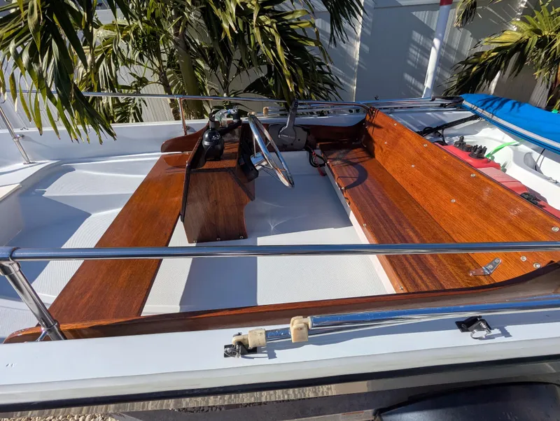 Slide: The Image of 1987 Boston Whaler 150 Super Sport boat interior with wooden seating and steering wheel. - 9