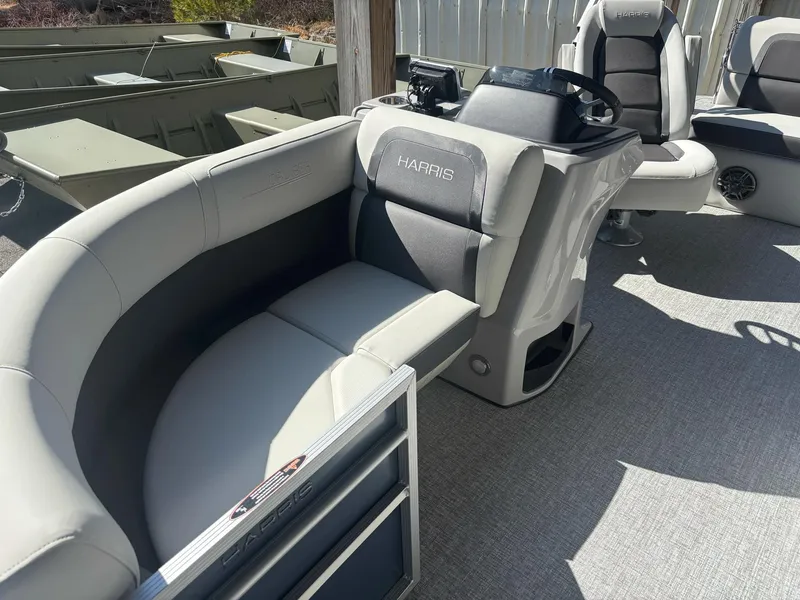 Slide: The Image of 2025 Harris Cruiser 190 pontoon boat interior with gray seating and steering console. - 1