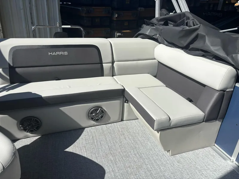 Slide: The Image of 2025 Harris Cruiser 190 boat interior with gray seating and built-in speakers. - 6