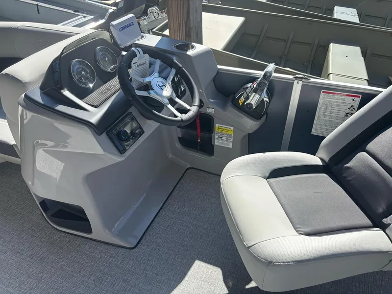 Slide: The Image of 2025 Harris Cruiser 190 boat interior with steering wheel and dashboard controls. - 7