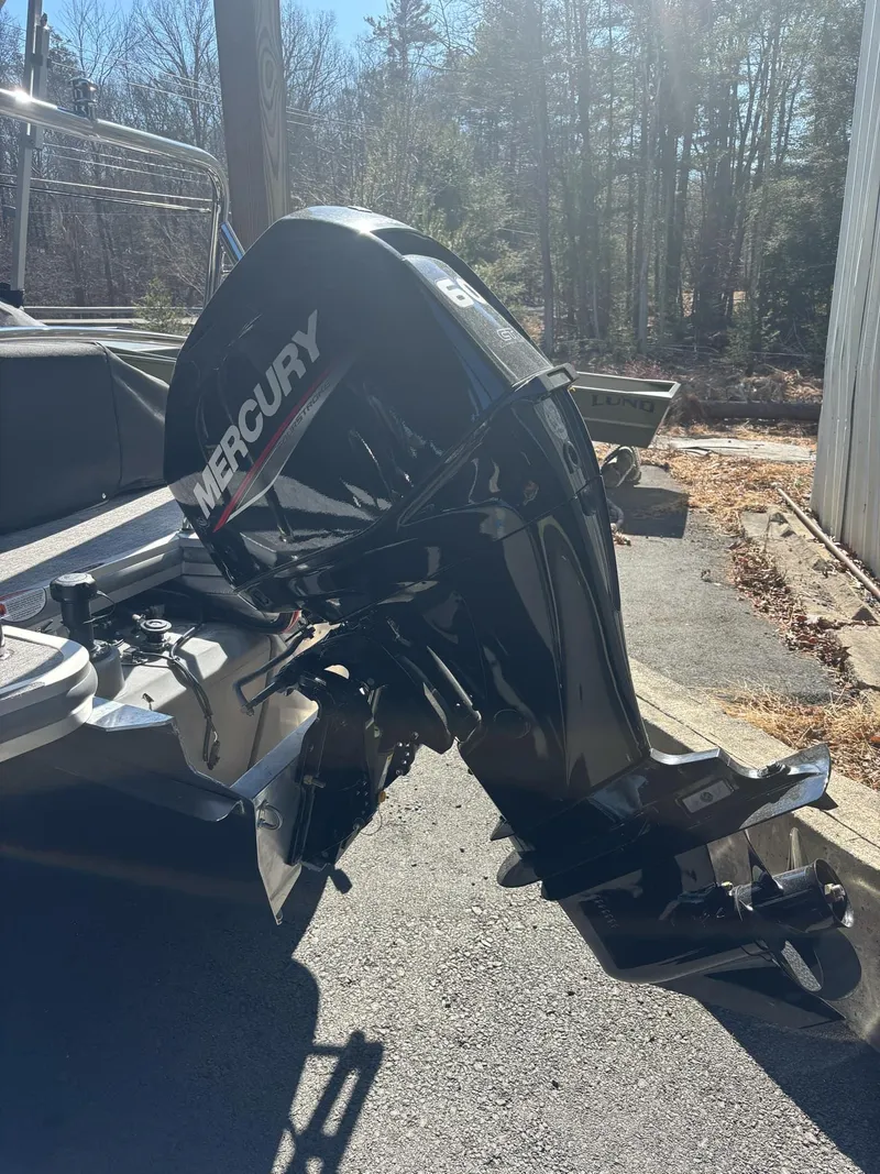 Slide: The Image of 2025 Harris Cruiser 190 with Mercury outboard motor in a sunny outdoor setting. - 9