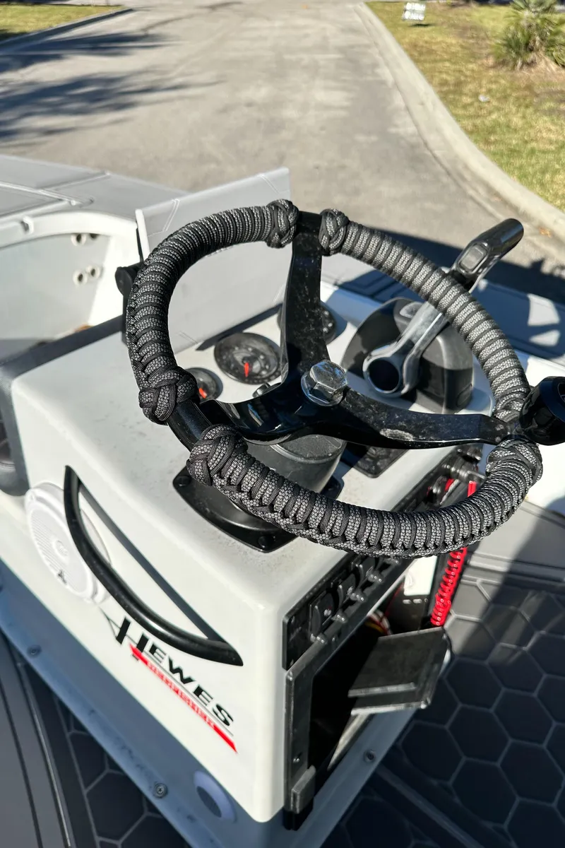 Slide: The Image of 1996 Hewes 18 Redfisher boat steering console with wrapped wheel and controls. - 17