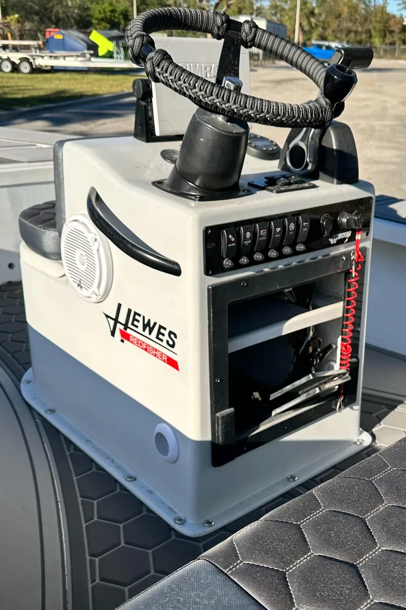 Slide: The Image of 1996 Hewes 18 Redfisher boat console with steering wheel and controls. - 18